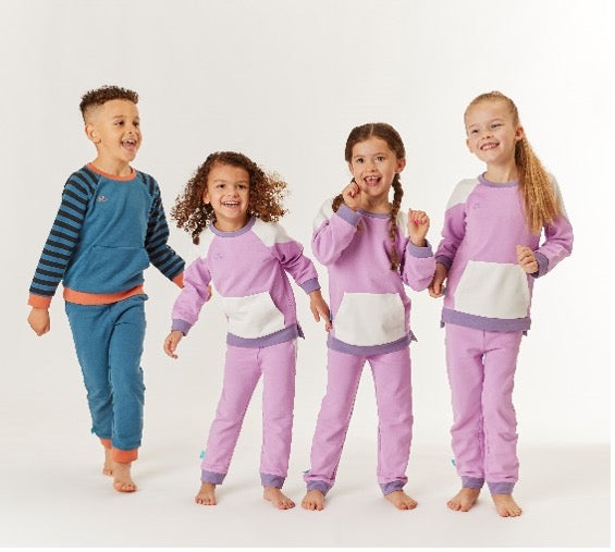 4 kids wearing bright coloured kids pyjamas